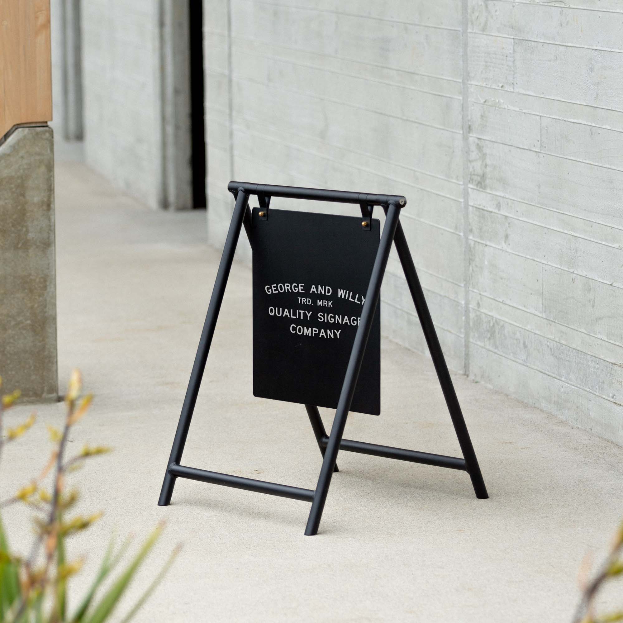 black metal A-Frame freestanding sign, business sidewalk pavement sign