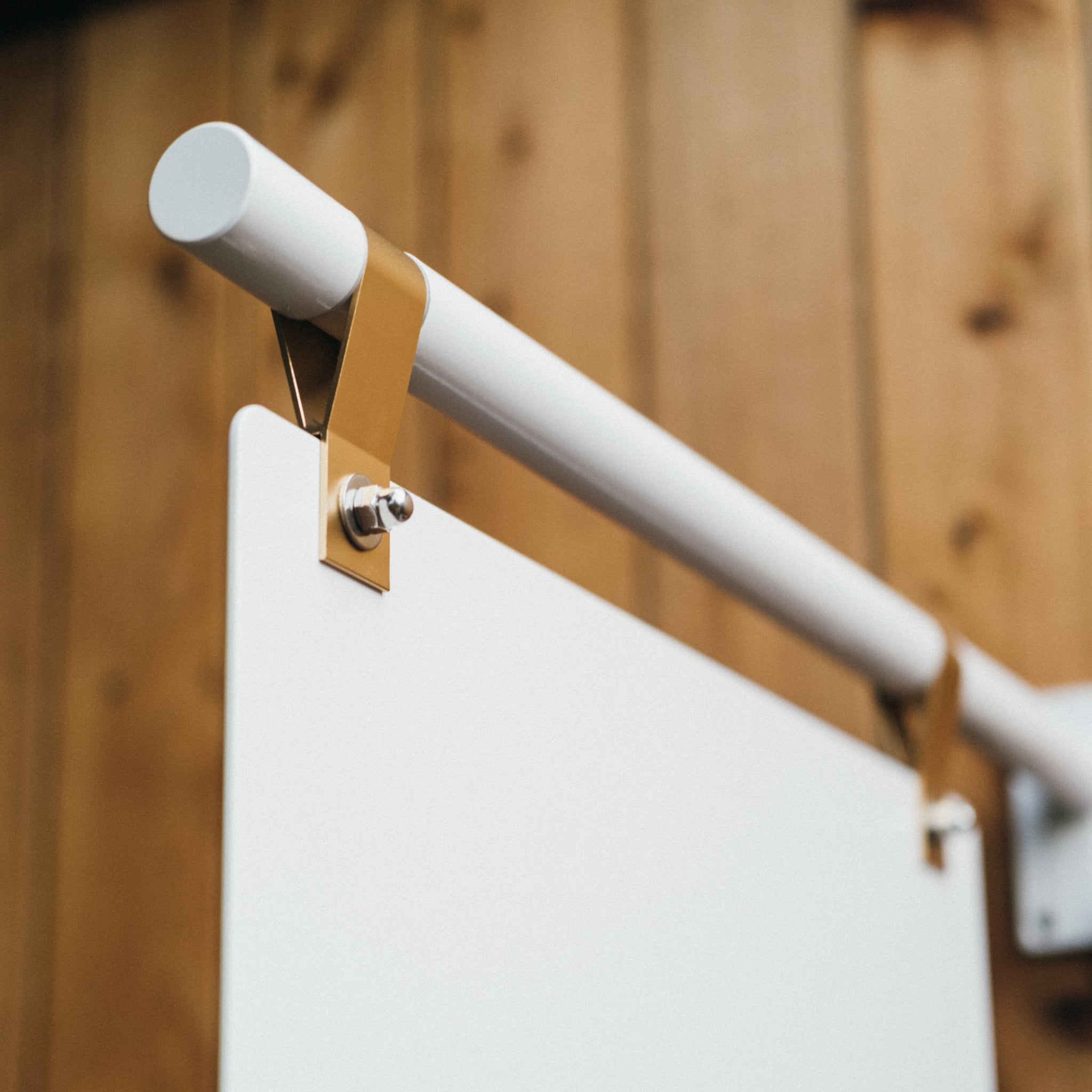 A white hanging square sign installed on a wooden wall, designed for businesses and stores to apply a logo